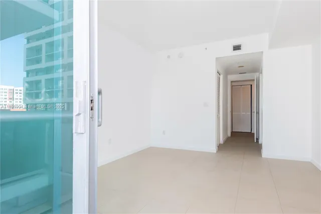 a view of an empty room with a window