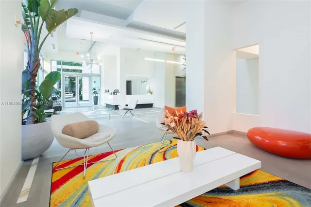 a lobby with furniture and floor to ceiling window