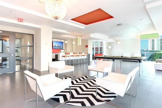 a living room with furniture and a dining table with wooden floor