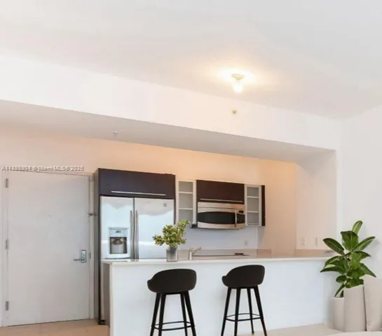 a kitchen with stainless steel appliances a microwave and cabinets