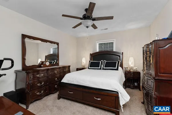 a bedroom with a bed and a dresser