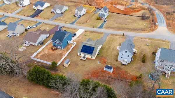 an aerial view of a house with a yard and garage
