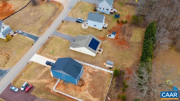 an aerial view of residential house with parking