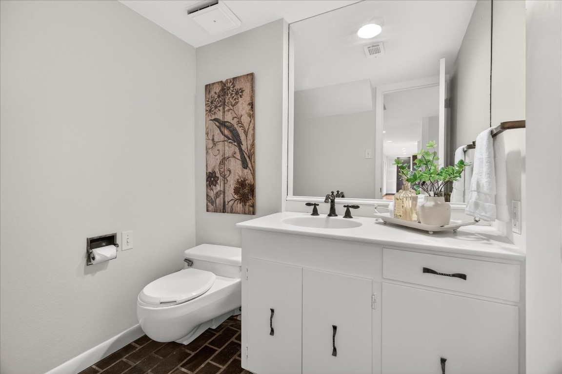 147 Valley Drive Liberty, TX 77575 - Photo 22 of 42 A convenient and stylish half bath is cleverly nestled under the stairway.