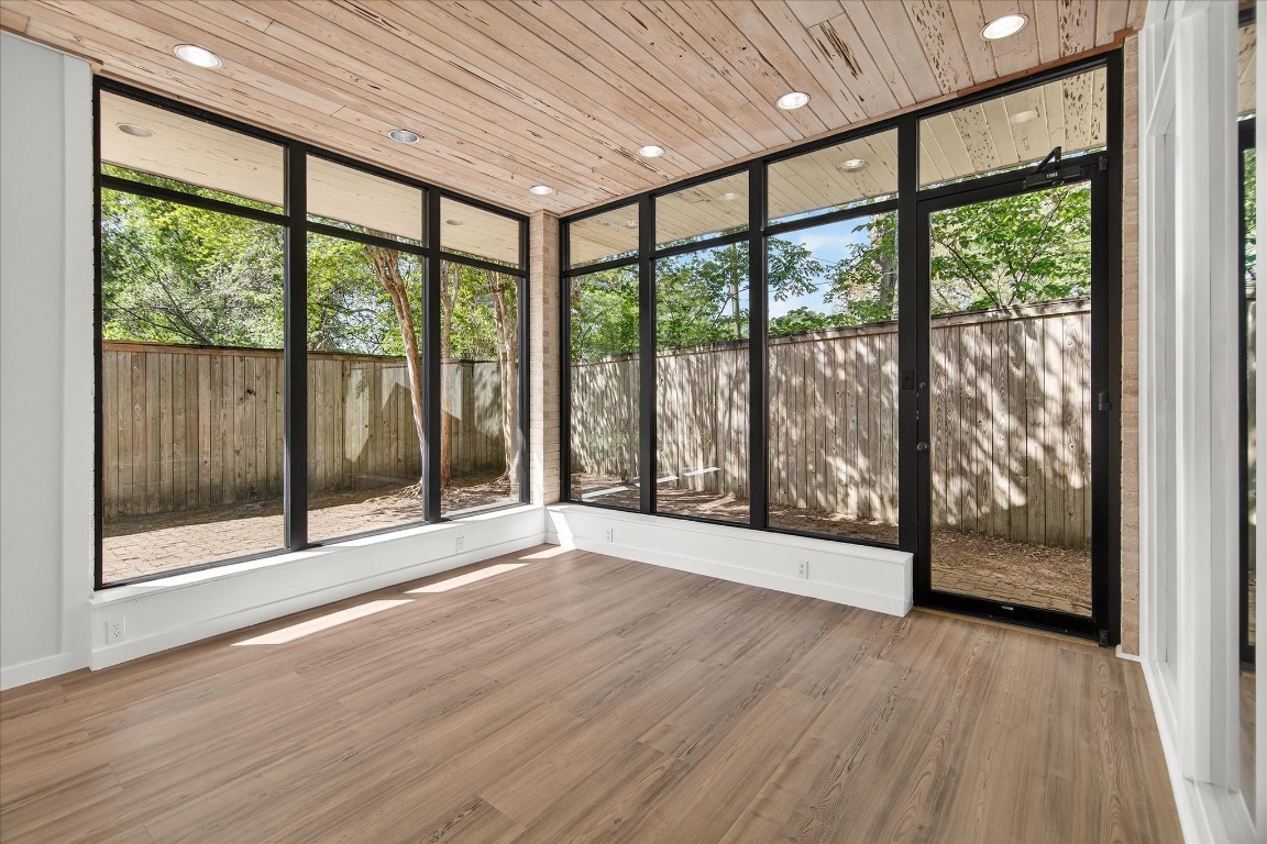 147 Valley Drive Liberty, TX 77575 - Photo 27 of 42 This versatile room is perfect as an office or a sunroom, offering serene views of the private patio surrounded by lush crepe myrtle trees.