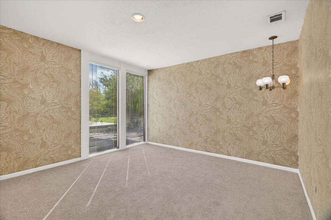 147 Valley Drive Liberty, TX 77575 - Photo 37 of 42 This spacious bedroom features new carpeting and charming vintage wallpaper.