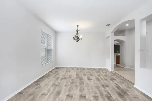 a view of a room with window and ceiling fan