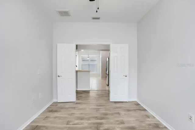 a view of a kitchen with kitchen island a sink wooden floor and window