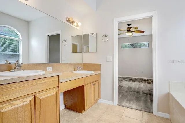 a bathroom with a granite countertop sink a toilet and bathtub