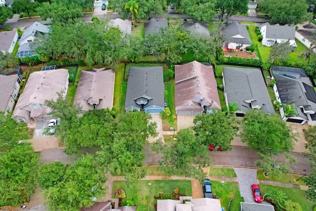 an aerial view of a house with a garden and swimming pool