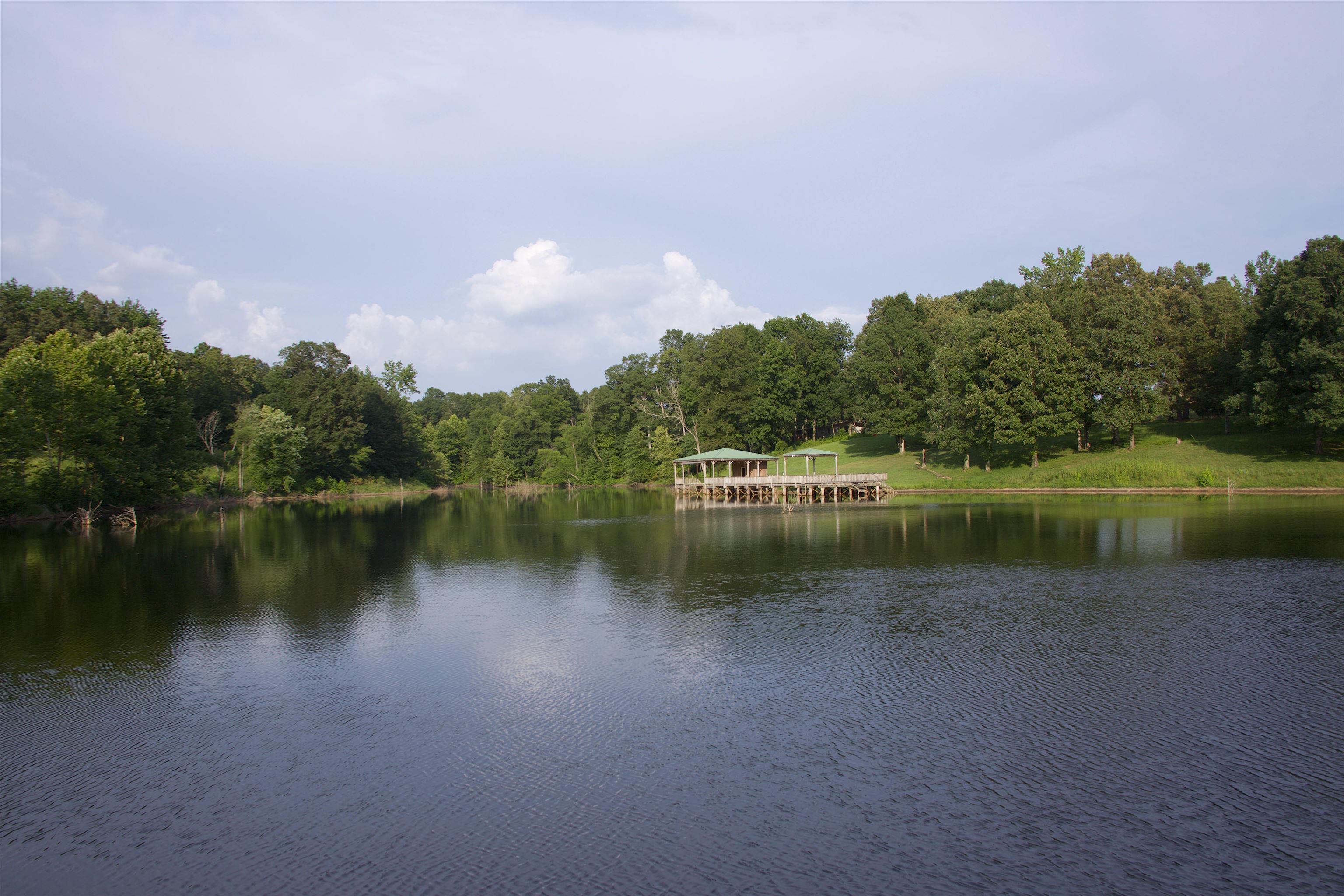 901 Duck Pond Road Holly Springs, MS 38635 - Photo 26 of 31 a view of a lake in between two of buildings