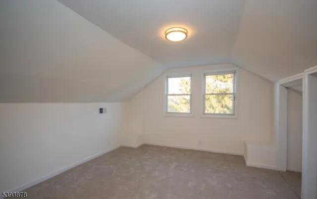 an empty room with wooden floor and closet