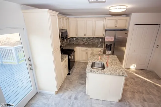 a kitchen with refrigerator a stove a sink and a refrigerator