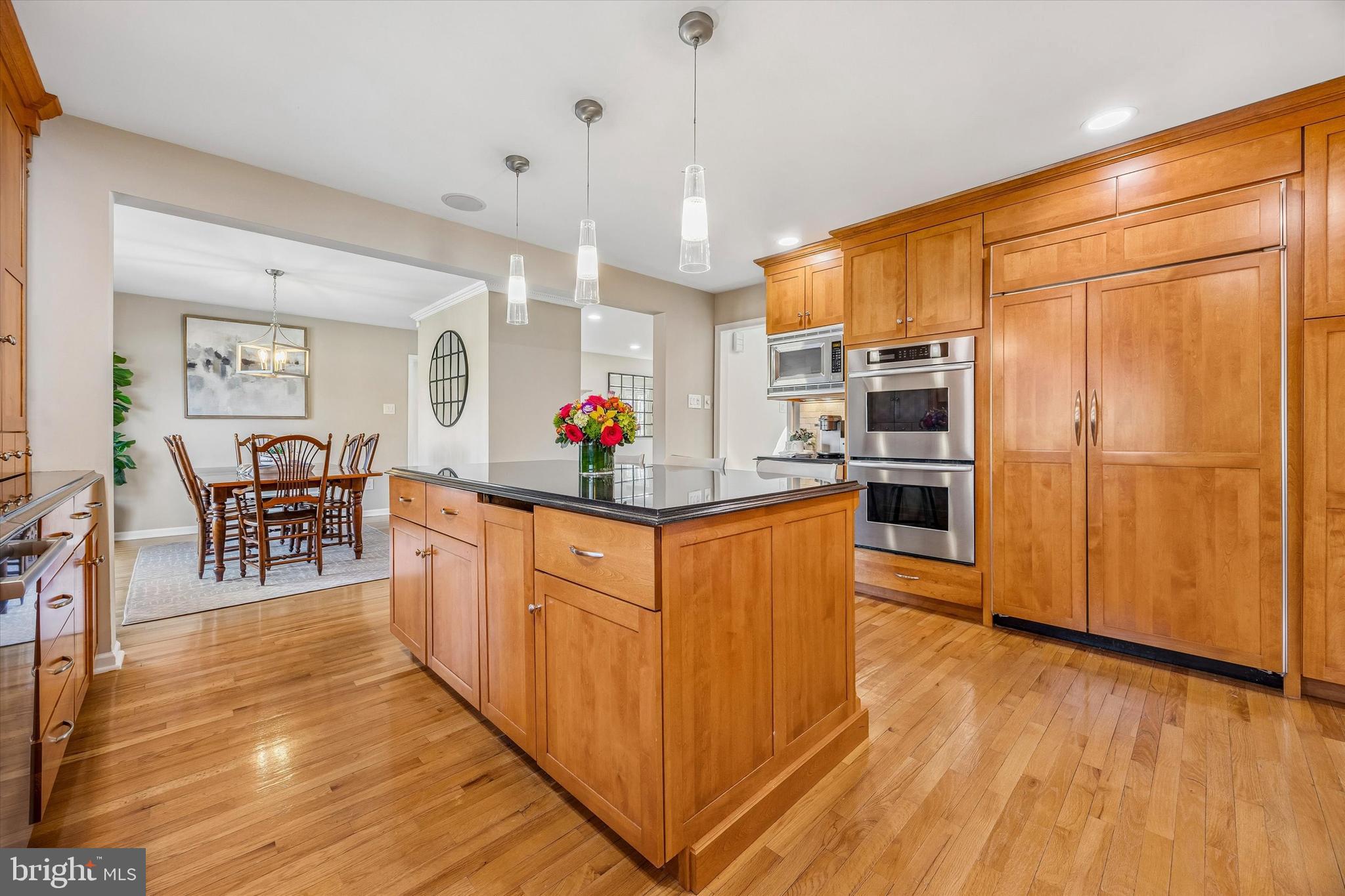 872 Roscommon Road Bryn Mawr, PA 19010 - Photo 13 of 49 a kitchen with stainless steel appliances granite countertop a refrigerator a stove top oven a sink dishwasher and wooden cabinets with wooden floor