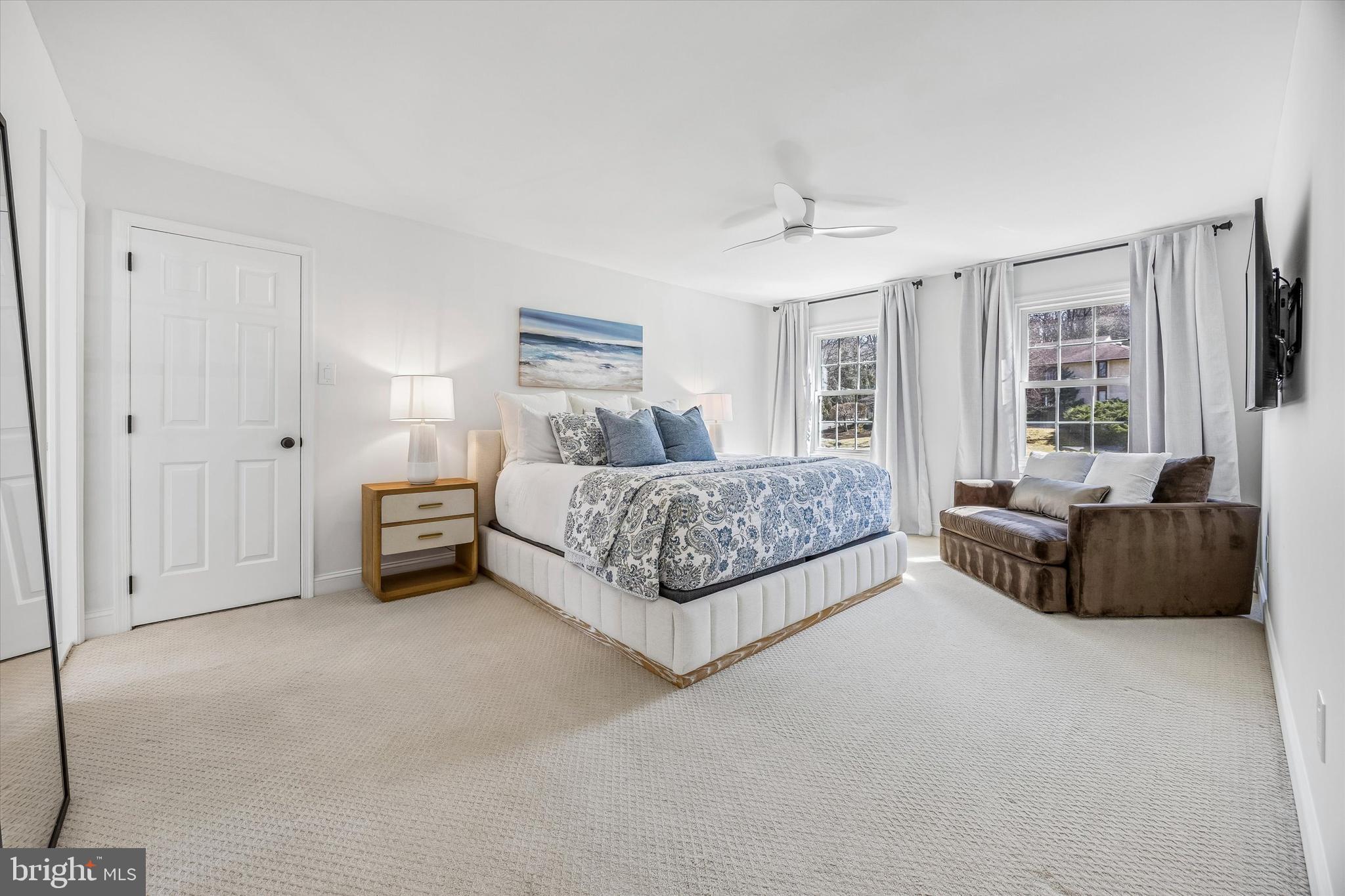 872 Roscommon Road Bryn Mawr, PA 19010 - Photo 22 of 49 a spacious bedroom with a bed and a couch