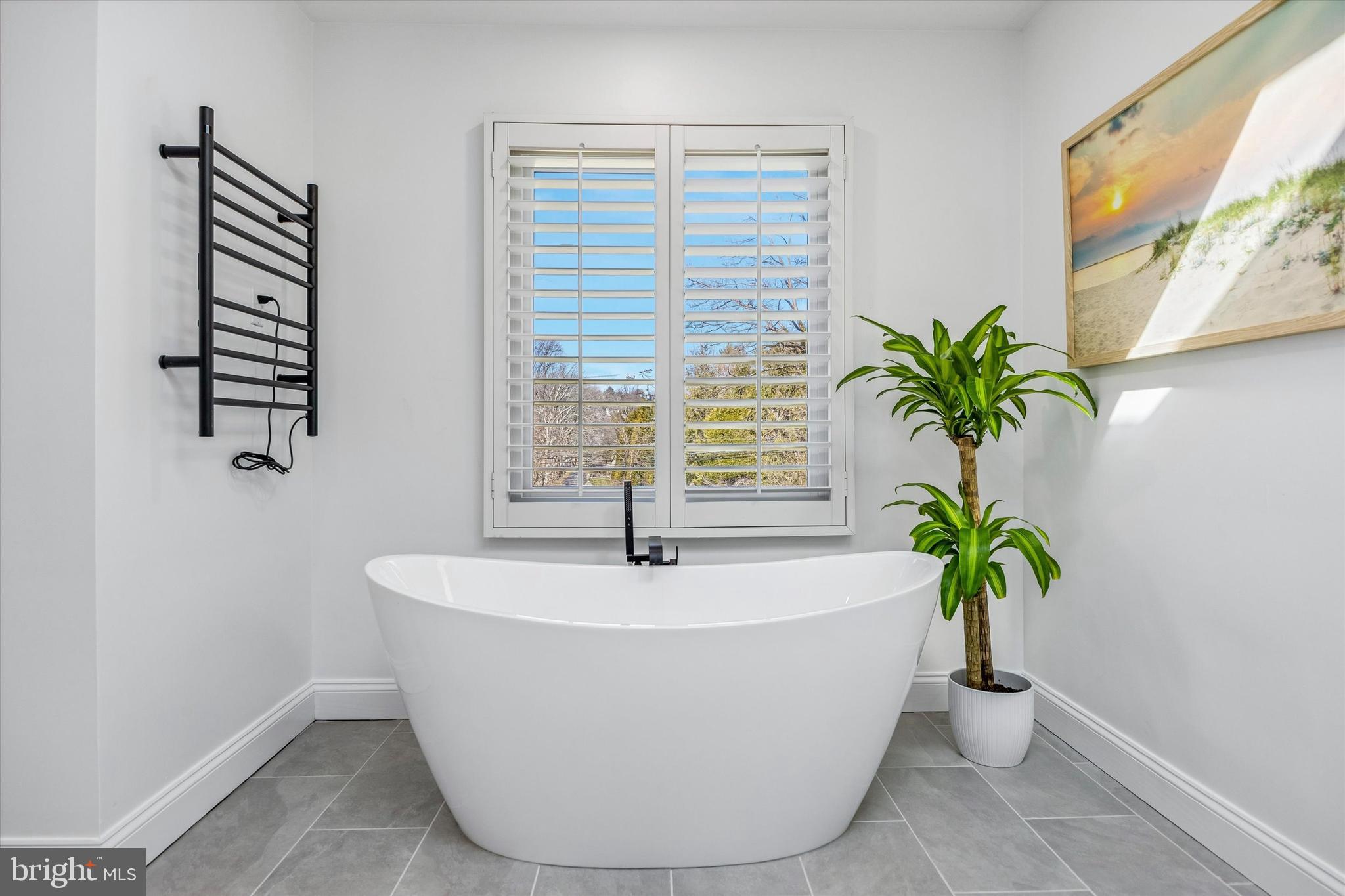 872 Roscommon Road Bryn Mawr, PA 19010 - Photo 25 of 49 a white bath tub sitting in a bathroom next to a window