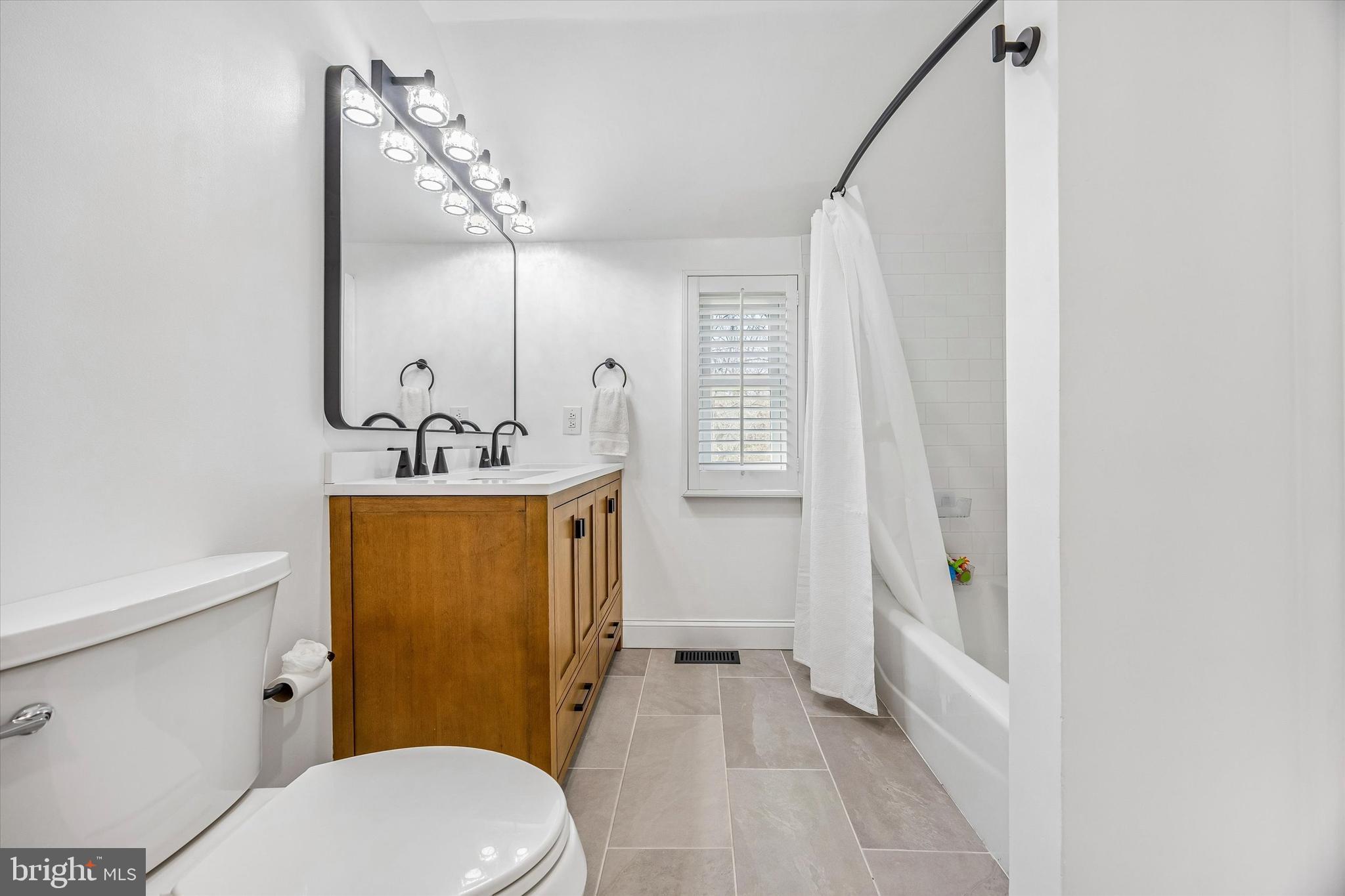 872 Roscommon Road Bryn Mawr, PA 19010 - Photo 36 of 49 a bathroom with a sink a toilet a mirror and shower