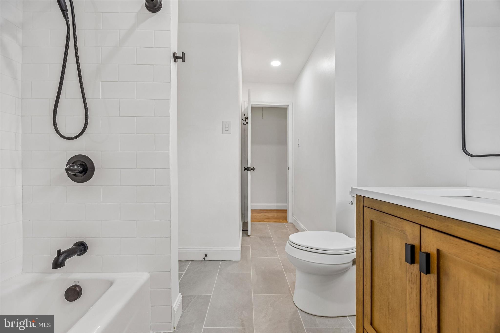 872 Roscommon Road Bryn Mawr, PA 19010 - Photo 37 of 49 a bathroom with a granite countertop bathtub shower and toilet