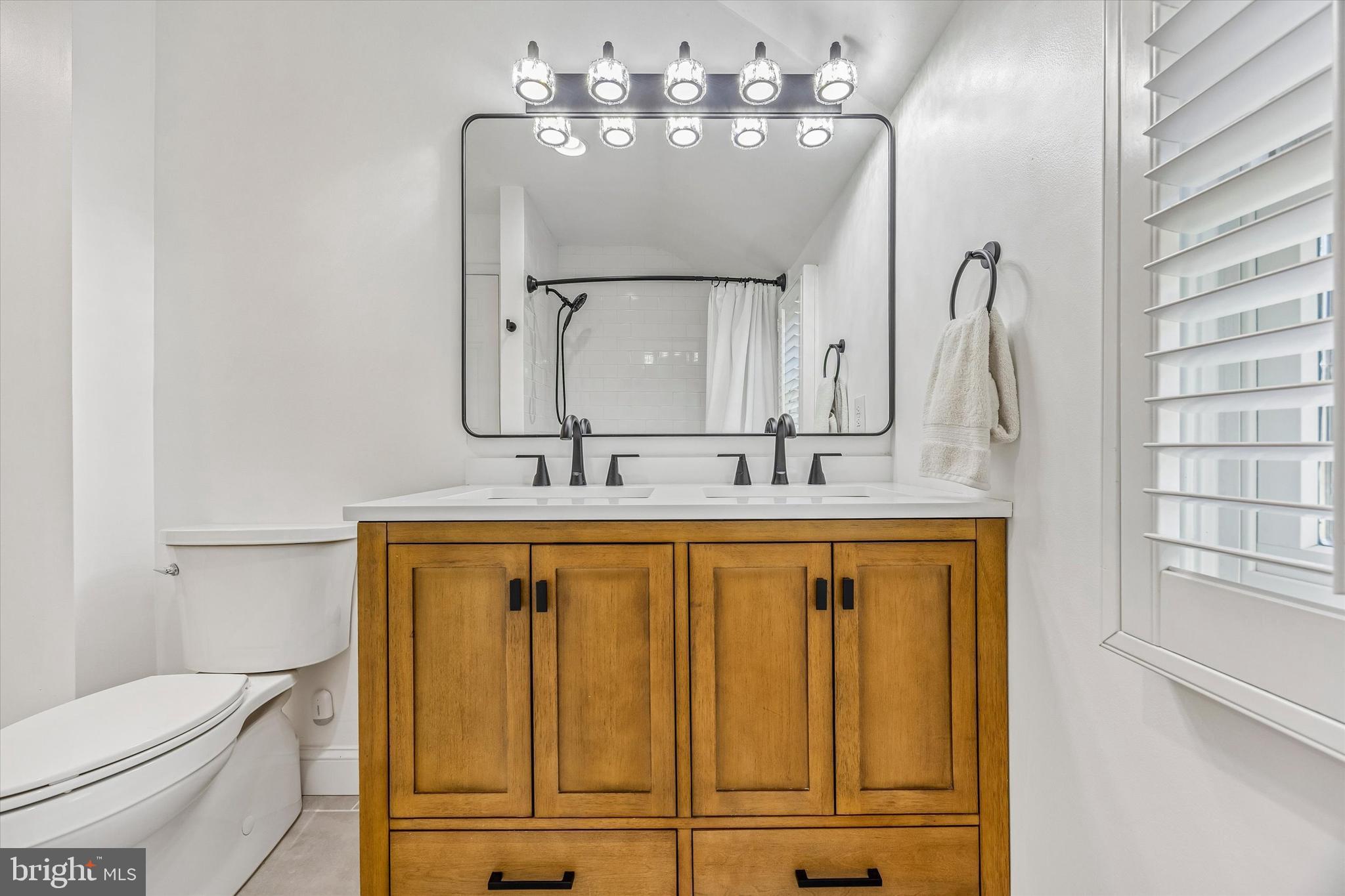872 Roscommon Road Bryn Mawr, PA 19010 - Photo 38 of 49 a bathroom with a double vanity sink mirror and toilet