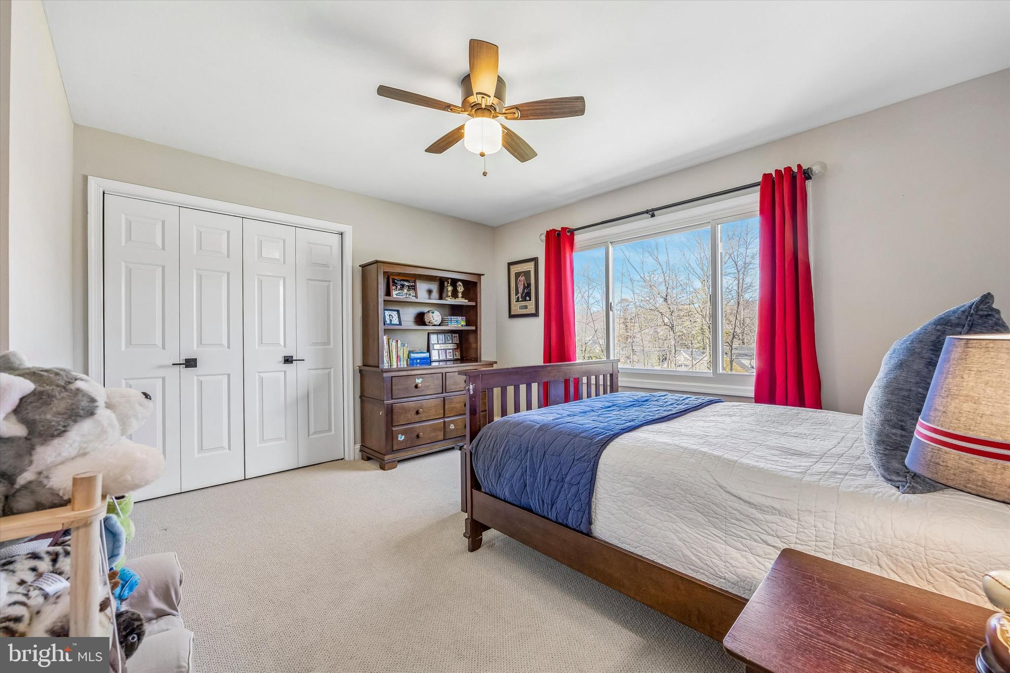 872 Roscommon Road Bryn Mawr, PA 19010 - Photo 40 of 49 a bedroom with a bed and a chandelier