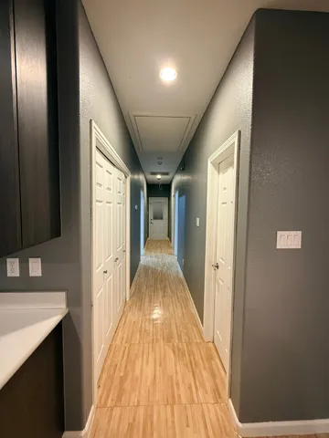 a view of hallway with wooden floor