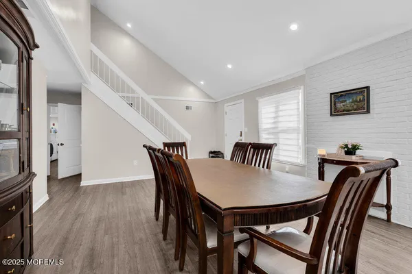 a view of a dining room with furniture and wooden floor