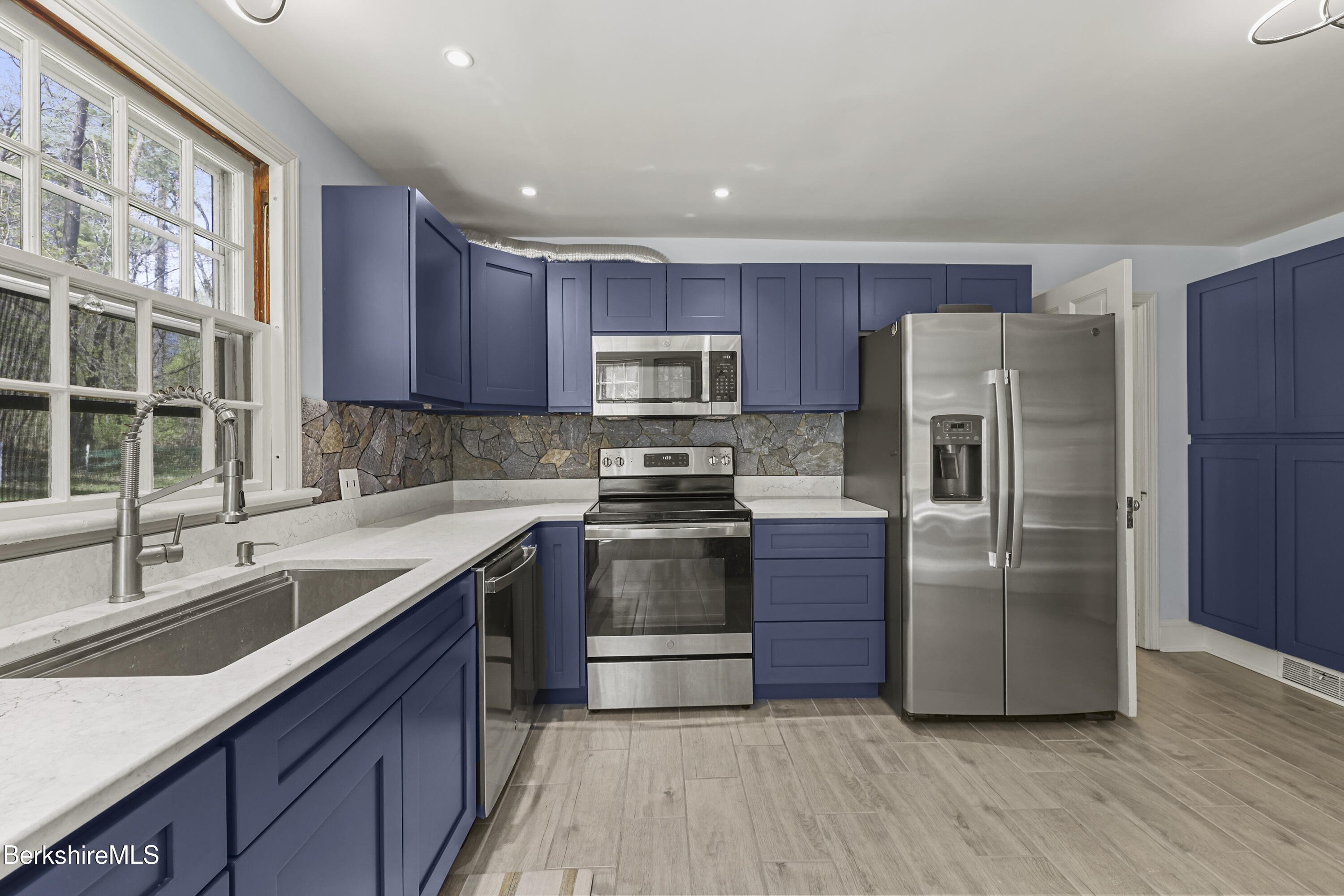 100 South Prospect Street Lee, MA 01238 - Photo 12 of 39 a kitchen with granite countertop a refrigerator and a sink