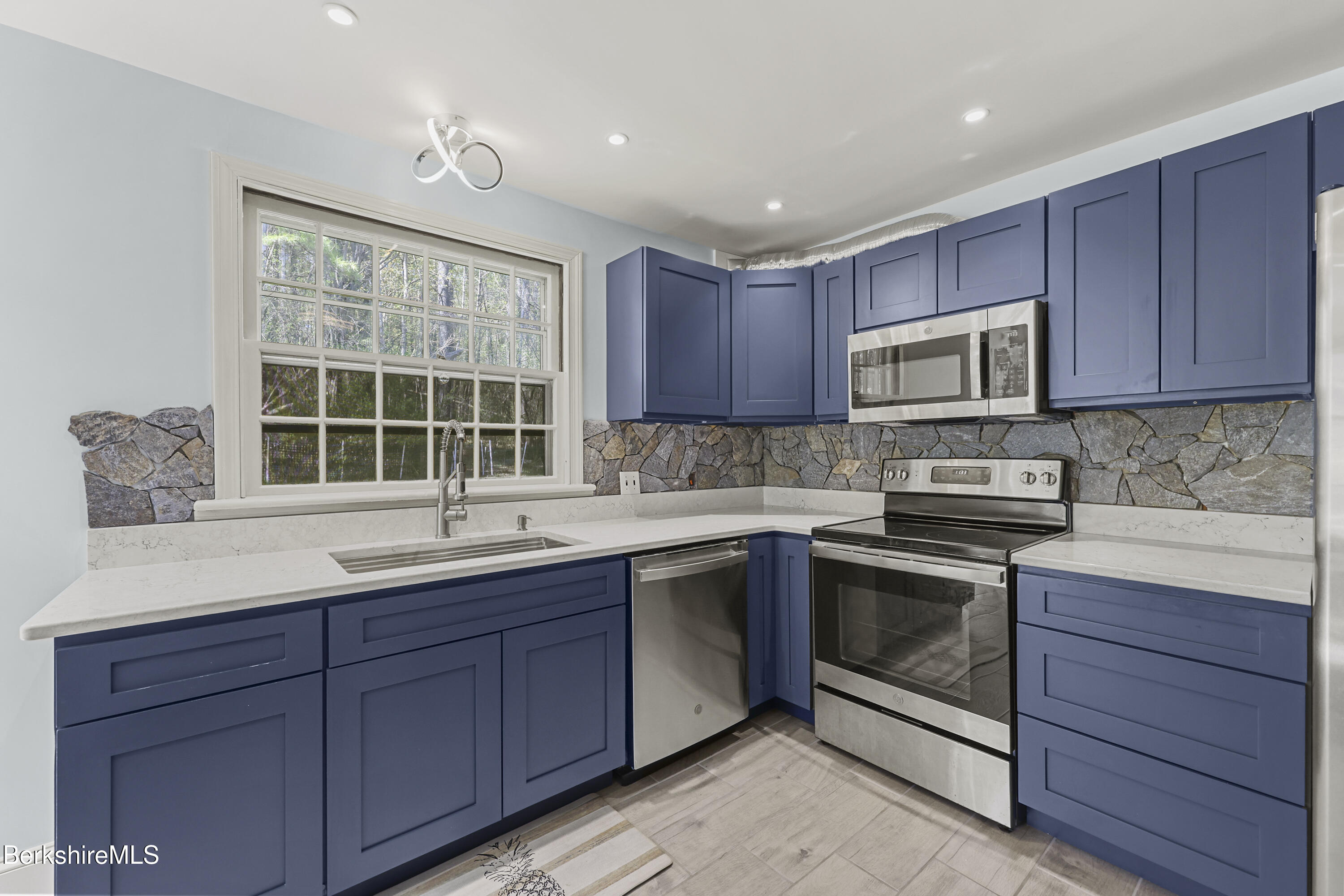 100 South Prospect Street Lee, MA 01238 - Photo 14 of 39 a kitchen with a sink stove and microwave