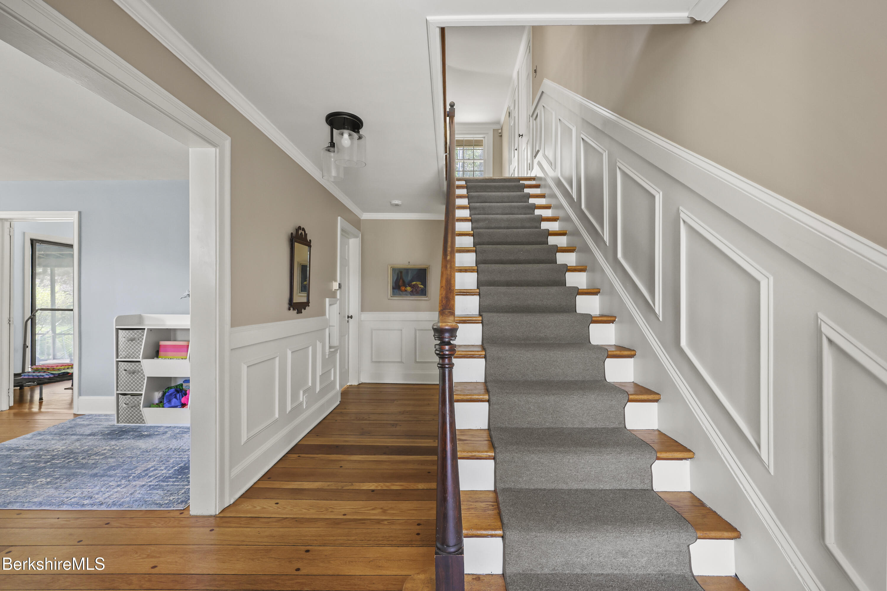 100 South Prospect Street Lee, MA 01238 - Photo 3 of 39 a view of staircase with lots of frames on wall and wooden floor
