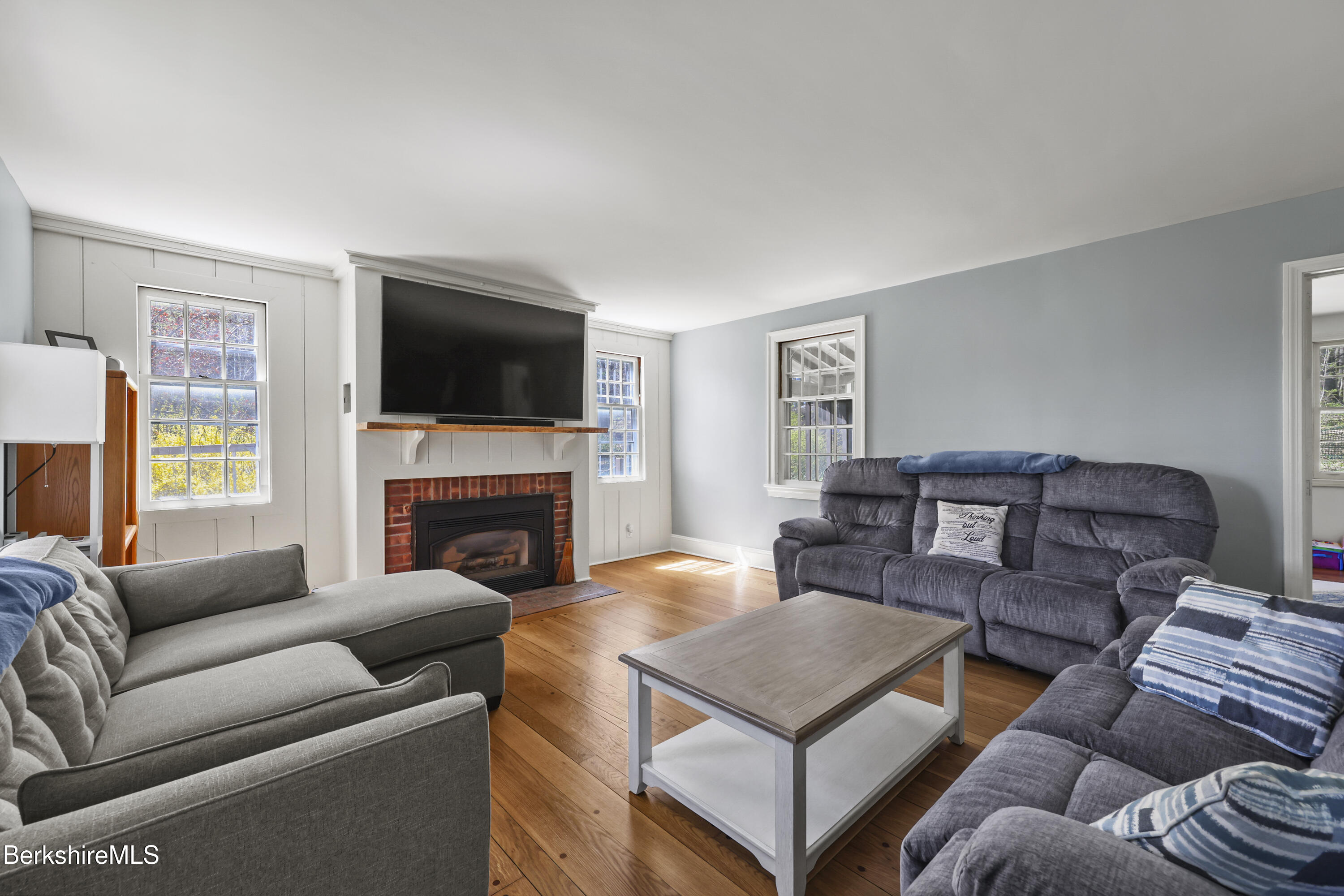 100 South Prospect Street Lee, MA 01238 - Photo 5 of 39 a living room with furniture a fireplace and a flat screen tv