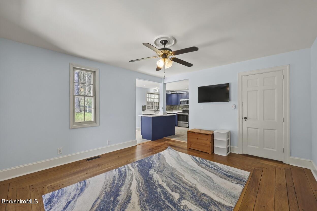 100 South Prospect Street Lee, MA 01238 - Photo 8 of 39 a living room with furniture and a flat screen tv