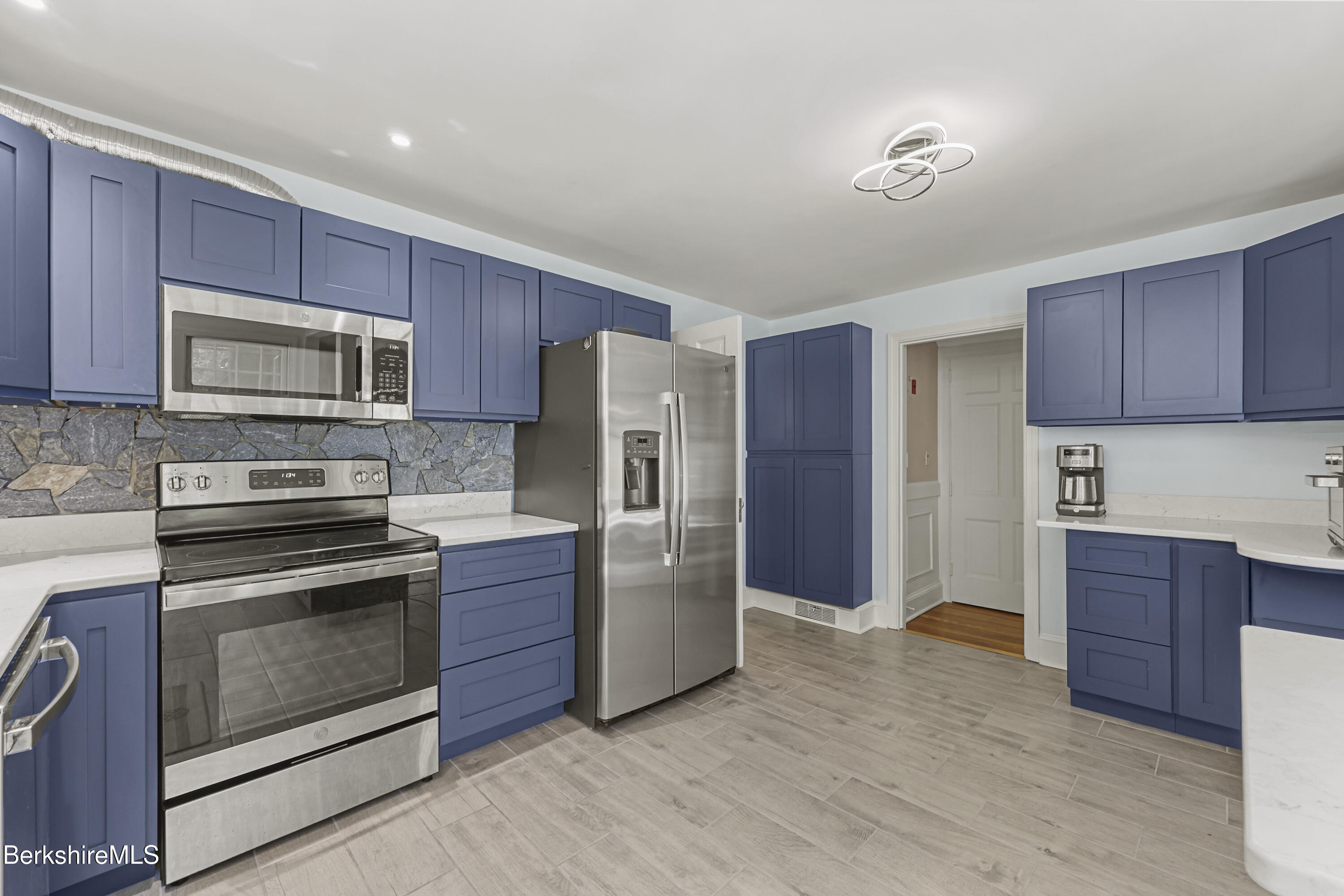 100 South Prospect Street Lee, MA 01238 - Photo 10 of 39 a kitchen with stainless steel appliances granite countertop a refrigerator stove and sink