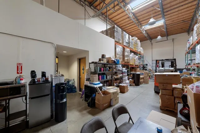 a living room with lots of furniture and clutter