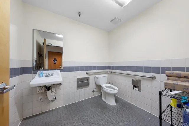a bathroom with a sink toilet and mirror