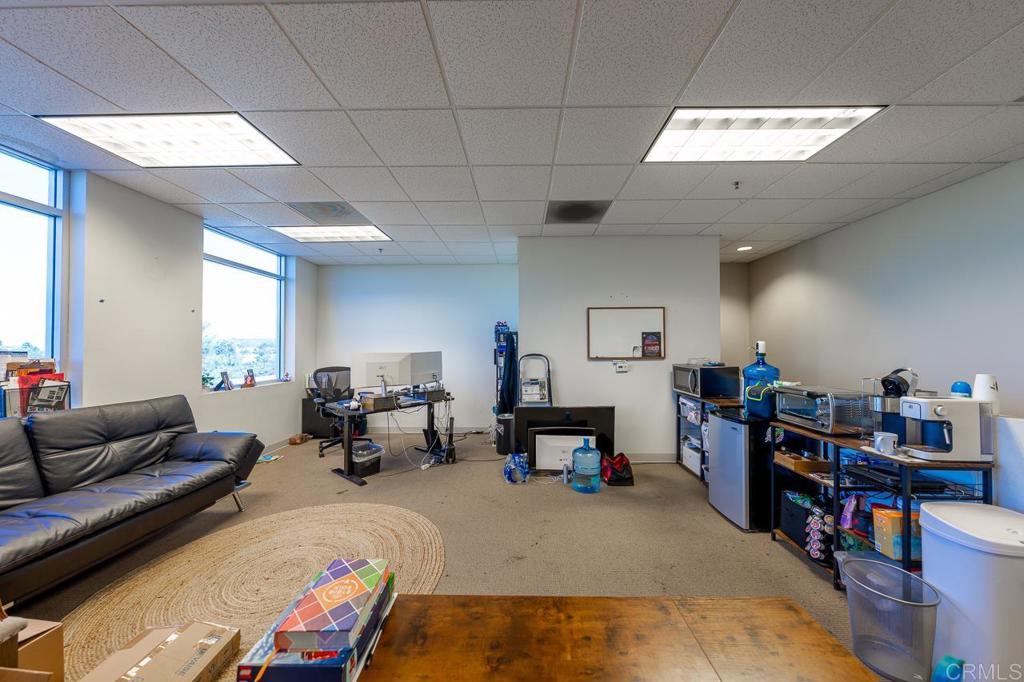 859 Bowsprit Road Chula Vista, CA 91914 - Photo 27 of 30 a living room with furniture and a dining table with bookshelf