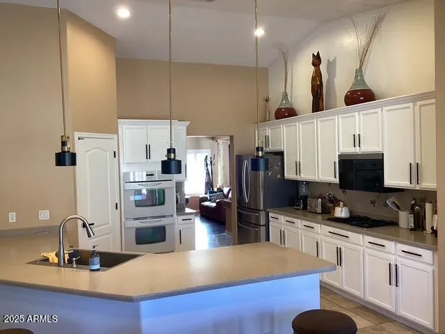 a living room with furniture and a ceiling fan