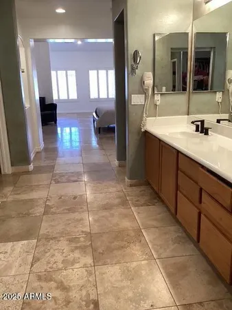 a bathroom with a sink a mirror and a shower