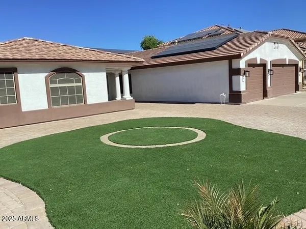 a view of a house with a backyard