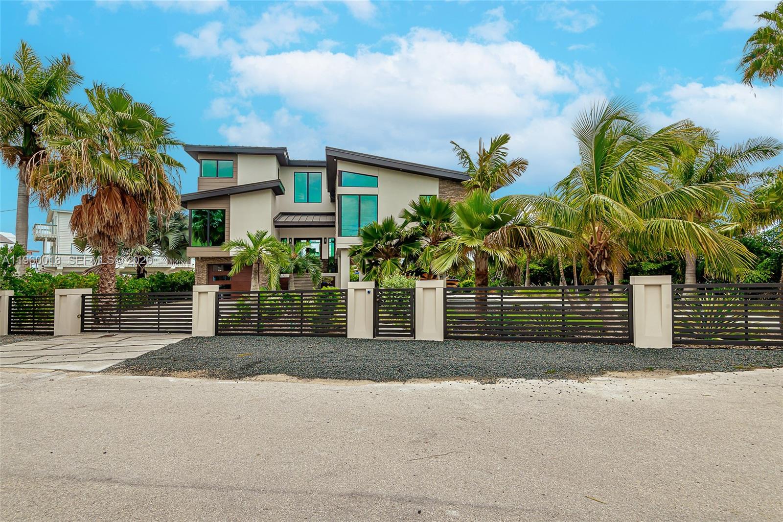 68 Mutiny Place Key Largo, FL 33037 - Photo 1 of 53 a front view of a house with a yard and a garage