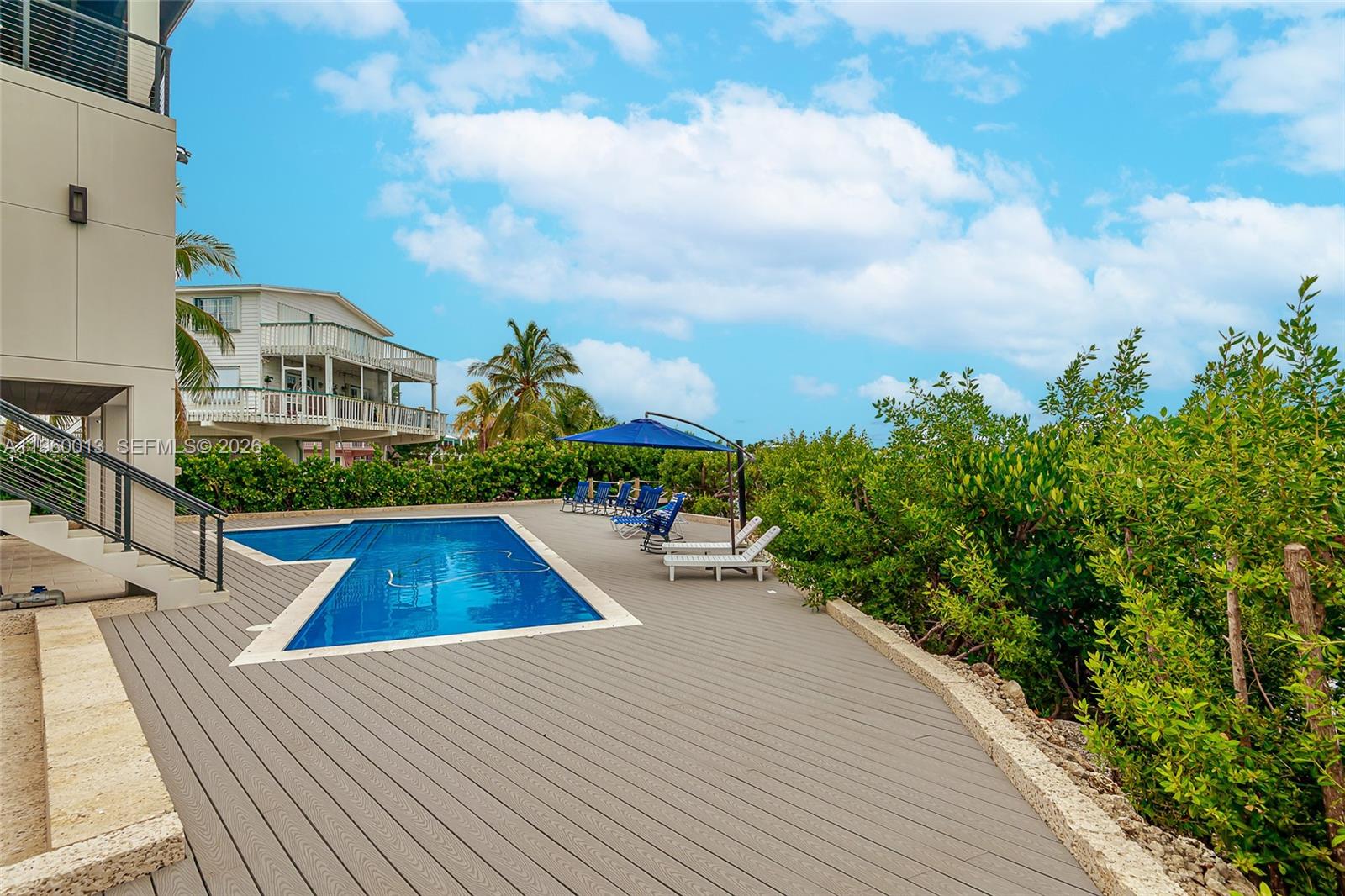 68 Mutiny Place Key Largo, FL 33037 - Photo 9 of 53 swimming pool view with plants and large trees