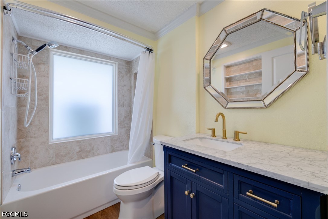 2639 Bridgeview Street Matlacha, FL 33993 - Photo 15 of 28 a bathroom with a granite countertop sink a toilet a vanity and bathtub