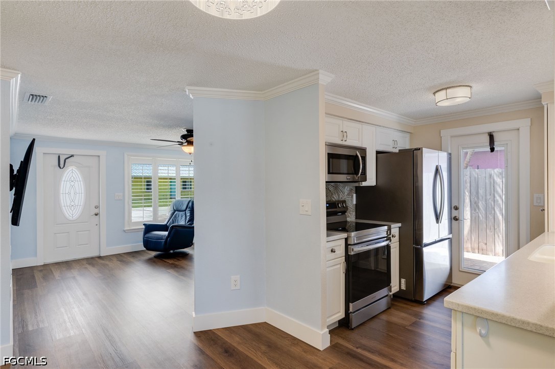 2639 Bridgeview Street Matlacha, FL 33993 - Photo 4 of 28 a kitchen with a refrigerator and a stove top oven