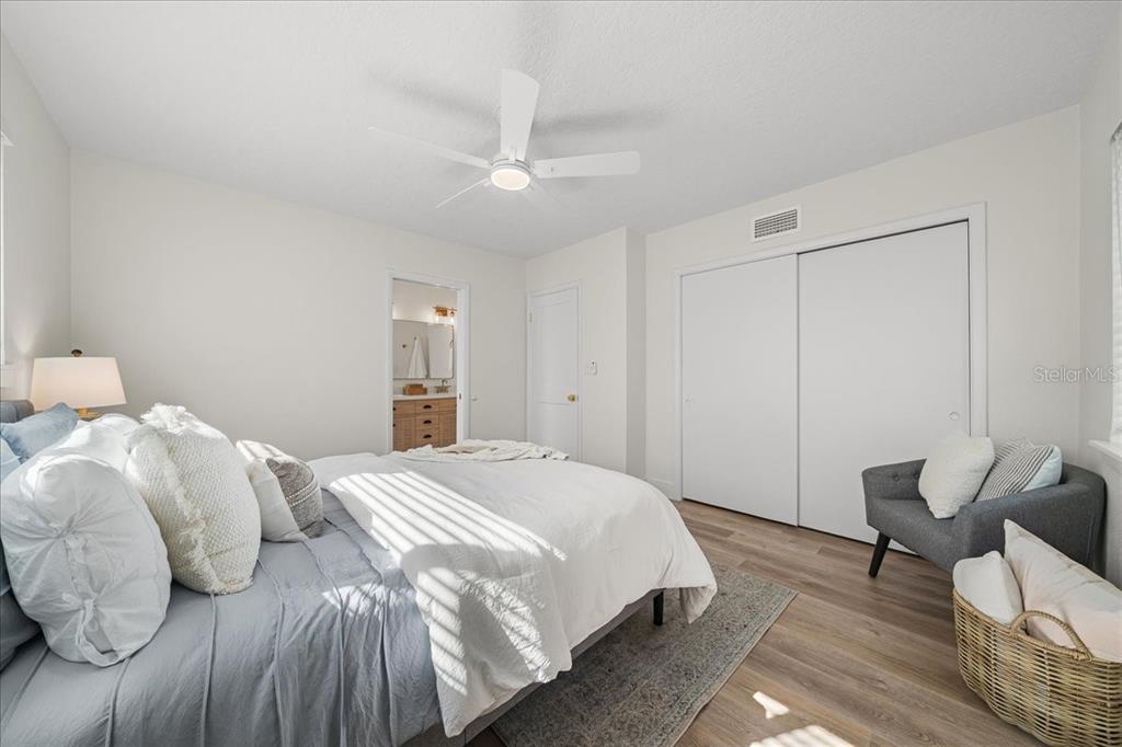 145 Southeast 3rd Street Satellite Beach, FL 32937 - Photo 11 of 29 a bedroom with a bed and a chair