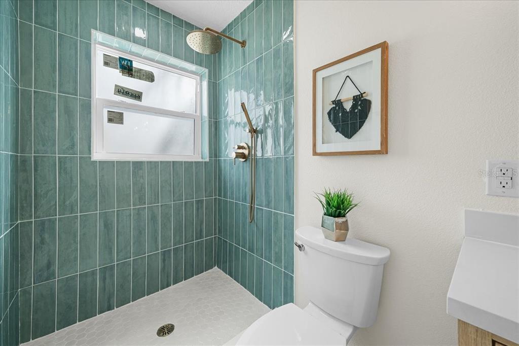 145 Southeast 3rd Street Satellite Beach, FL 32937 - Photo 12 of 29 a bathroom with a toilet sink and mirror