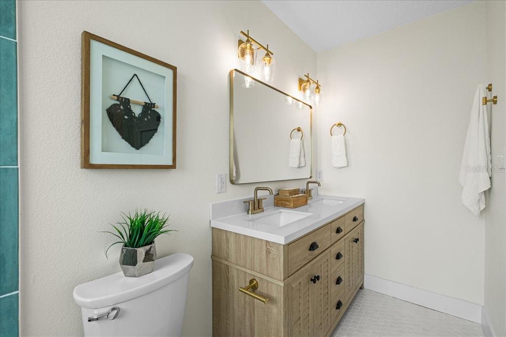 145 Southeast 3rd Street Satellite Beach, FL 32937 - Photo 13 of 29 a bathroom with a sink vanity and a mirror