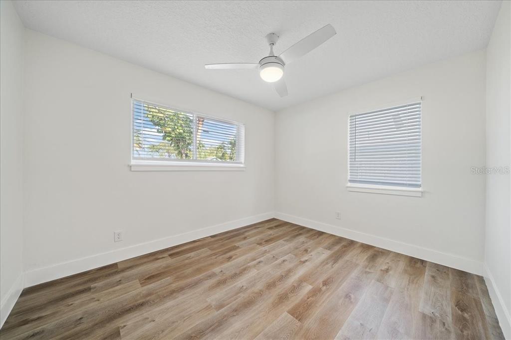 145 Southeast 3rd Street Satellite Beach, FL 32937 - Photo 15 of 29 an empty room with wooden floor and windows