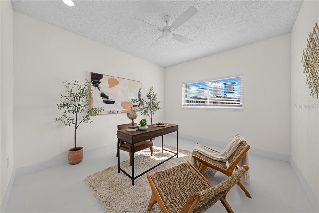 145 Southeast 3rd Street Satellite Beach, FL 32937 - Photo 17 of 29 a living room with furniture a chandelier and a potted plant