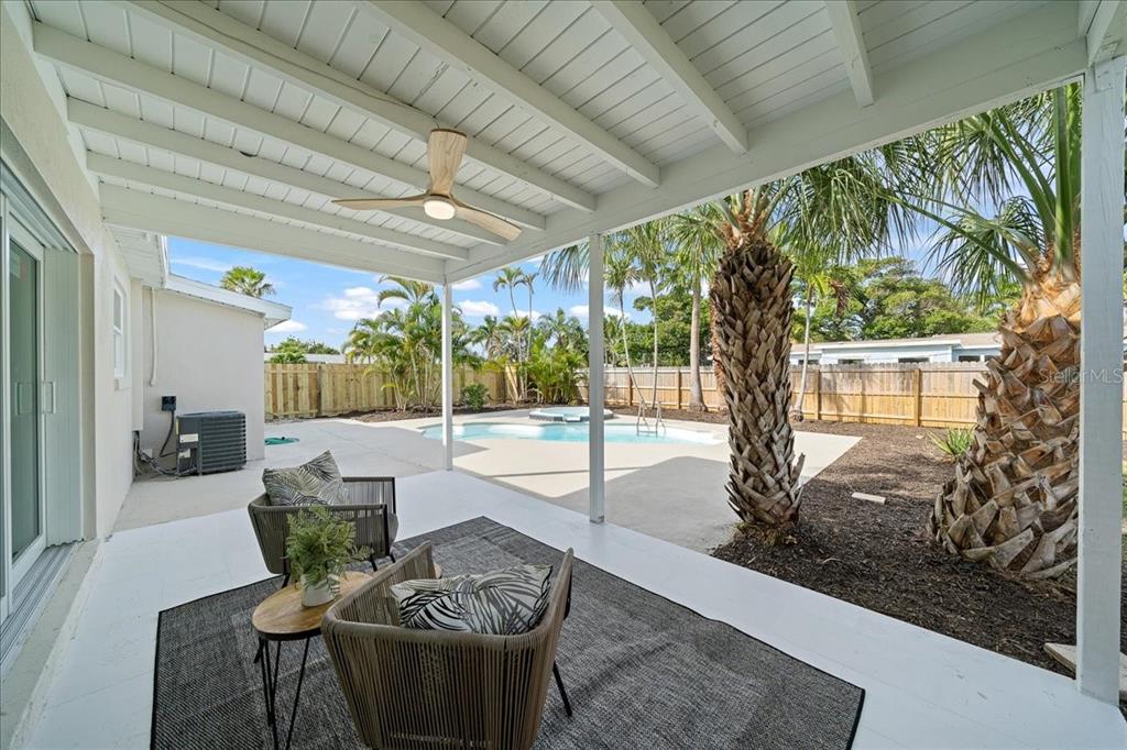145 Southeast 3rd Street Satellite Beach, FL 32937 - Photo 19 of 29 a living room with patio furniture and a floor to ceiling window