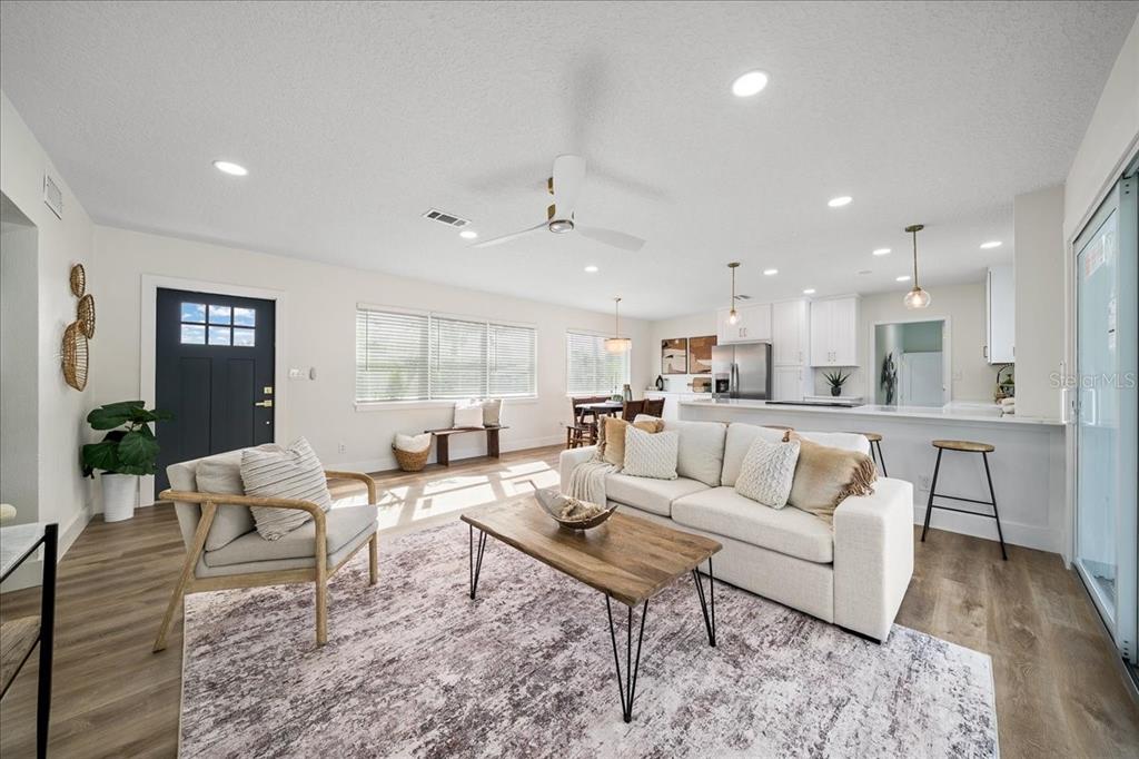 145 Southeast 3rd Street Satellite Beach, FL 32937 - Photo 9 of 29 a living room with furniture kitchen view and a wooden floor