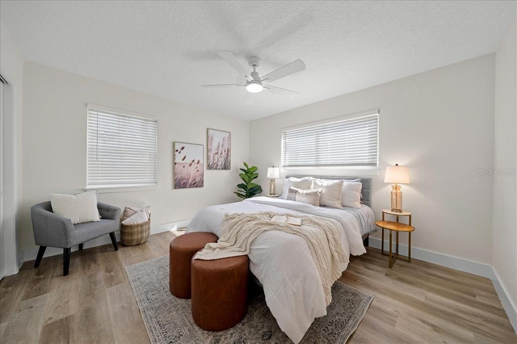 145 Southeast 3rd Street Satellite Beach, FL 32937 - Photo 10 of 29 a spacious bedroom with a bed and a couch